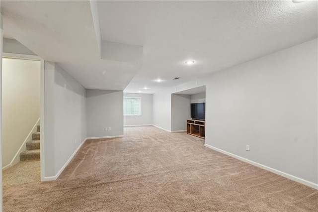 9729 Prairie Creek Rd, Lenexa, KS 66220 - below grade area featuring carpet floors, stairs, and recessed lighting