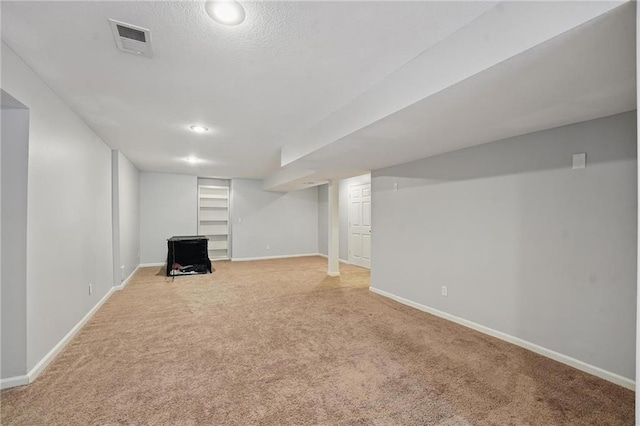 9729 Prairie Creek Rd, Lenexa, KS 66220 - finished basement featuring light carpet, a textured ceiling, and built in features