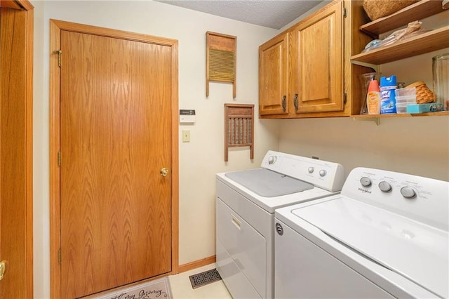 2721 SW Herefordshire Rd, Topeka, KS 66614 - laundry room with washing machine and dryer, cabinet space, and baseboards