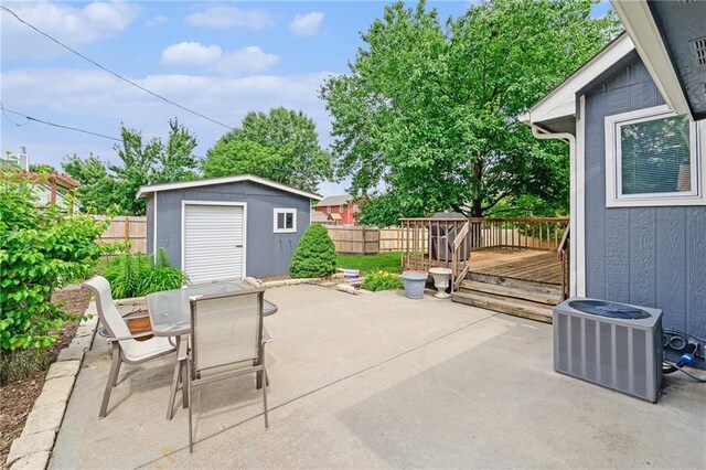 2721 SW Herefordshire Rd, Topeka, KS 66614 - fenced backyard with a deck, outdoor dining space, a patio area, and central AC