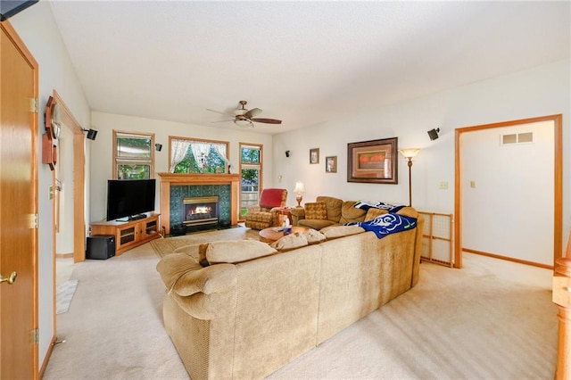 2721 SW Herefordshire Rd, Topeka, KS 66614 - living area featuring light colored carpet, ceiling fan, a fireplace, and baseboards