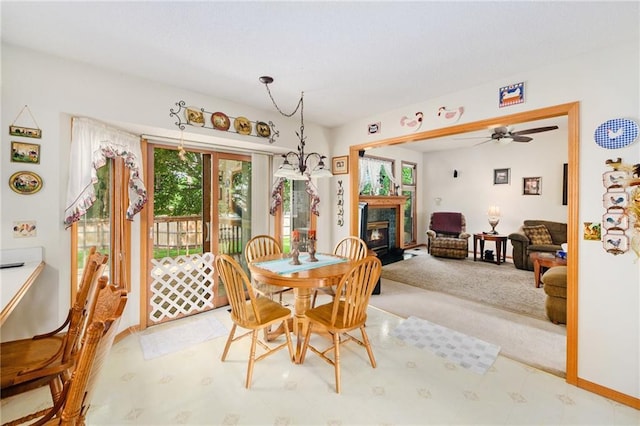 2721 SW Herefordshire Rd, Topeka, KS 66614 - carpeted dining space featuring a glass covered fireplace, baseboards, and ceiling fan