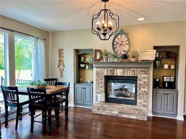 1402 NW Cedar Ct, Grain Valley, MO 64029 - dining space featuring a chandelier, wood finished floors, a fireplace, baseboards, and recessed lighting
