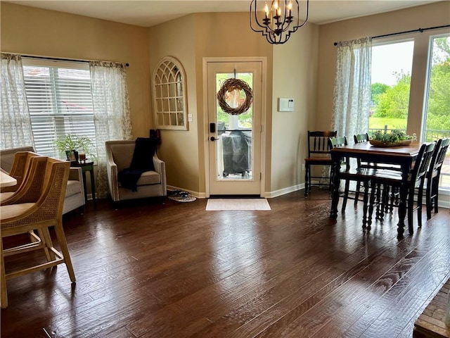 1402 NW Cedar Ct, Grain Valley, MO 64029 - dining room with a chandelier, hardwood / wood-style floors, and baseboards