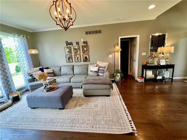 1402 NW Cedar Ct, Grain Valley, MO 64029 - living area featuring wood finished floors, a chandelier, ornamental molding, and baseboards