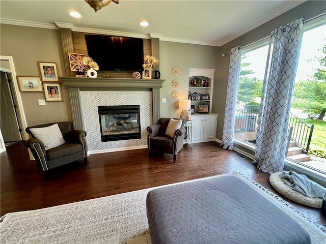 1402 NW Cedar Ct, Grain Valley, MO 64029 - living room with wood finished floors, ornamental molding, a fireplace, and recessed lighting