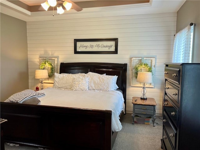 1402 NW Cedar Ct, Grain Valley, MO 64029 - bedroom featuring wood walls, carpet floors, ornamental molding, and a ceiling fan