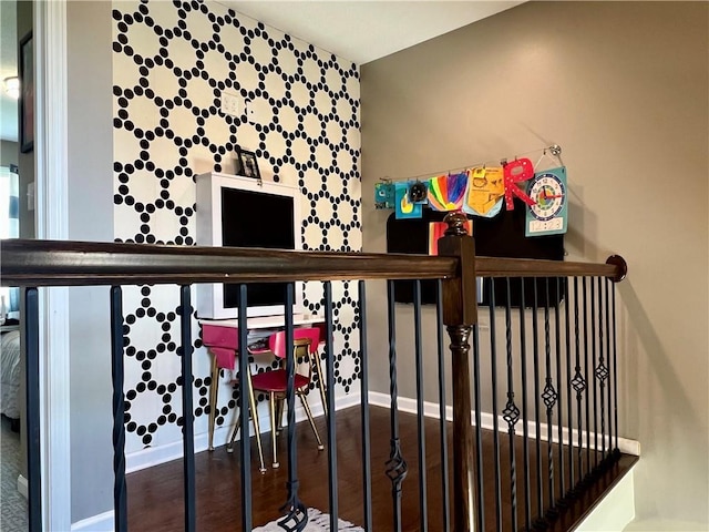 1402 NW Cedar Ct, Grain Valley, MO 64029 - stairway featuring baseboards, an accent wall, and wood finished floors