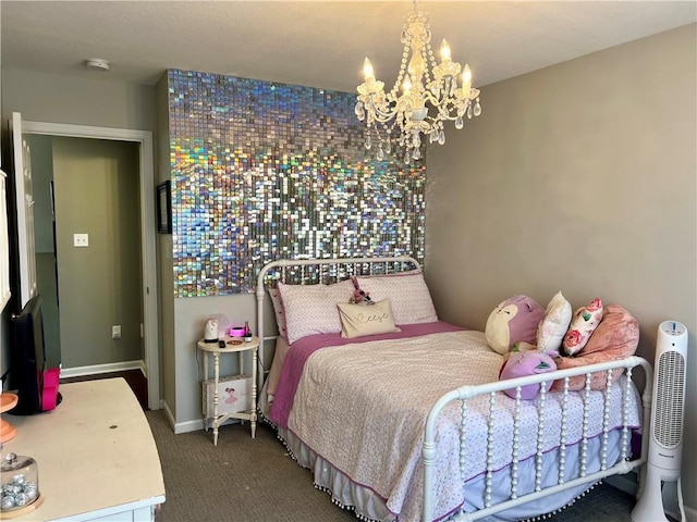 1402 NW Cedar Ct, Grain Valley, MO 64029 - bedroom featuring a chandelier, dark colored carpet, and baseboards