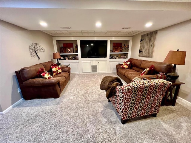 1402 NW Cedar Ct, Grain Valley, MO 64029 - carpeted living room with baseboards and built in shelves