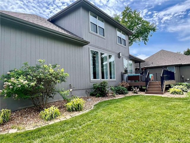 1402 NW Cedar Ct, Grain Valley, MO 64029 - rear view of house with a wooden deck, a lawn, and a shingled roof