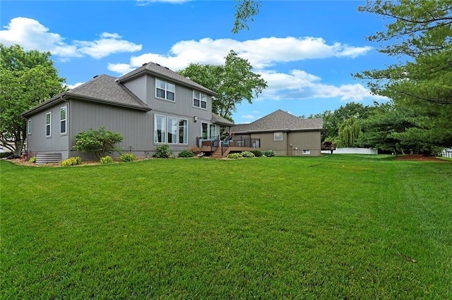 1402 NW Cedar Ct, Grain Valley, MO 64029 - rear view of property featuring a deck, a yard, and roof with shingles