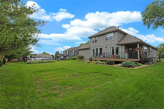 1402 NW Cedar Ct, Grain Valley, MO 64029 - rear view of house featuring french doors, a deck, and a lawn