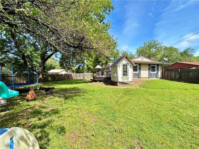 400 S 7th St, Arma, KS 66712 - view of yard featuring a trampoline and a deck