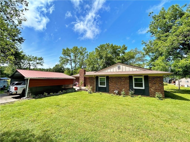 400 S 7th St, Arma, KS 66712 - view of front of house featuring a front yard, a chimney, and brick siding