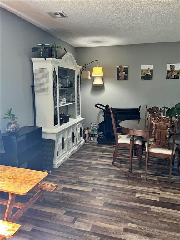 400 S 7th St, Arma, KS 66712 - dining room with wood finished floors and a textured ceiling