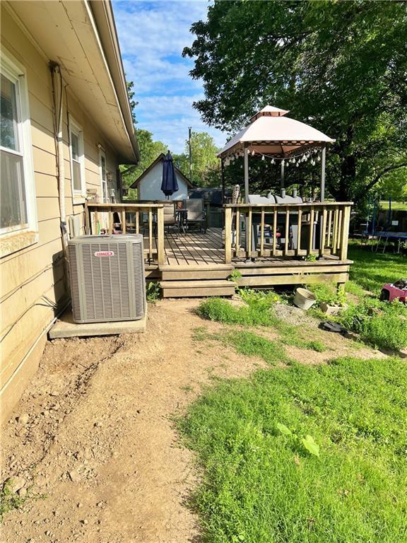 400 S 7th St, Arma, KS 66712 - view of yard with a gazebo, cooling unit, a trampoline, and a wooden deck