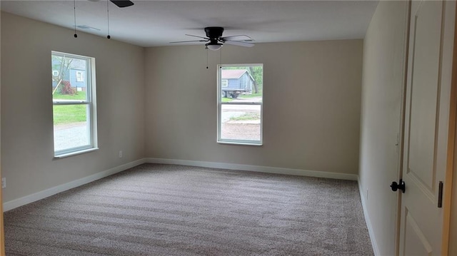 208 W Marshall St, Mayview, MO 64071 - empty room with ceiling fan, healthy amount of natural light, carpet flooring, and baseboards