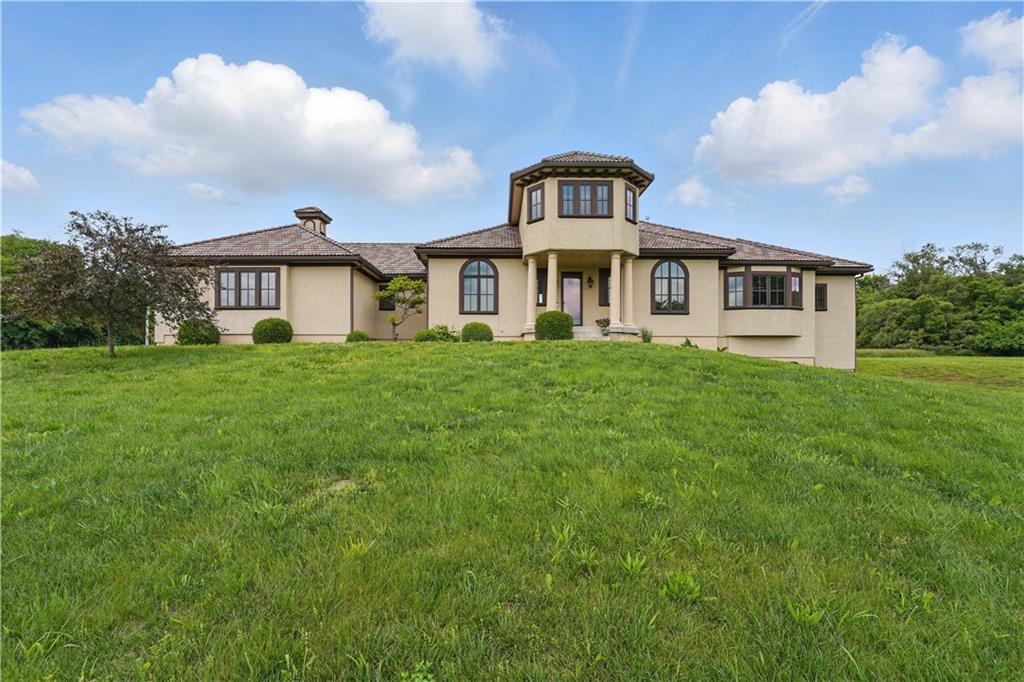 11426 E 233rd St, Peculiar, MO 64078 - view of front facade with stucco siding and a front yard