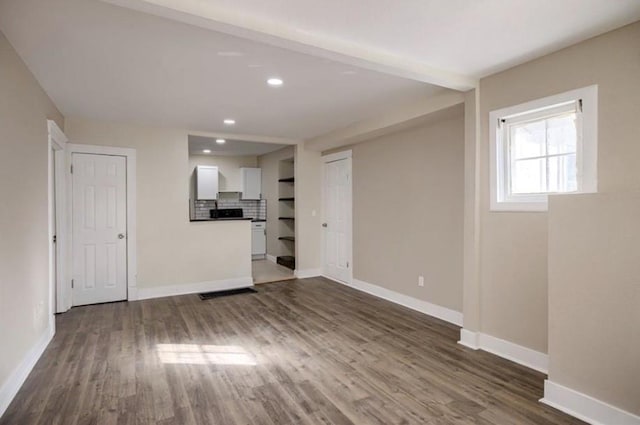 4204 E 60th Ter, Kansas City, MO 64130 - unfurnished living room with baseboards, dark wood-style flooring, and recessed lighting