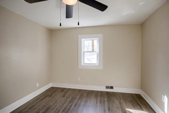 4204 E 60th Ter, Kansas City, MO 64130 - spare room featuring dark wood-style floors, baseboards, and ceiling fan