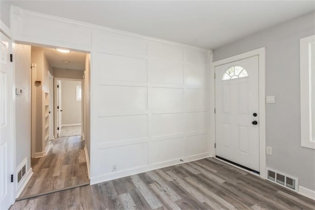 7119 E 111th Ter, Kansas City, MO 64134 - foyer entrance with wood finished floors, a decorative wall, and baseboards