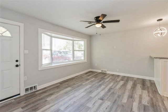 7119 E 111th Ter, Kansas City, MO 64134 - foyer entrance featuring wood finished floors, a ceiling fan, and baseboards