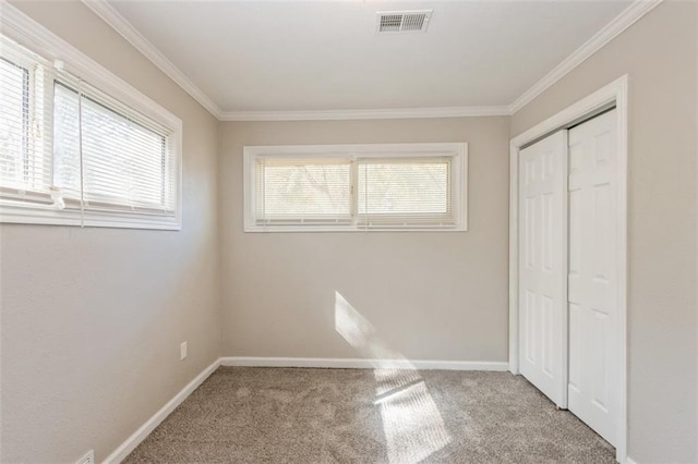 7119 E 111th Ter, Kansas City, MO 64134 - unfurnished bedroom with carpet flooring, ornamental molding, baseboards, and a closet