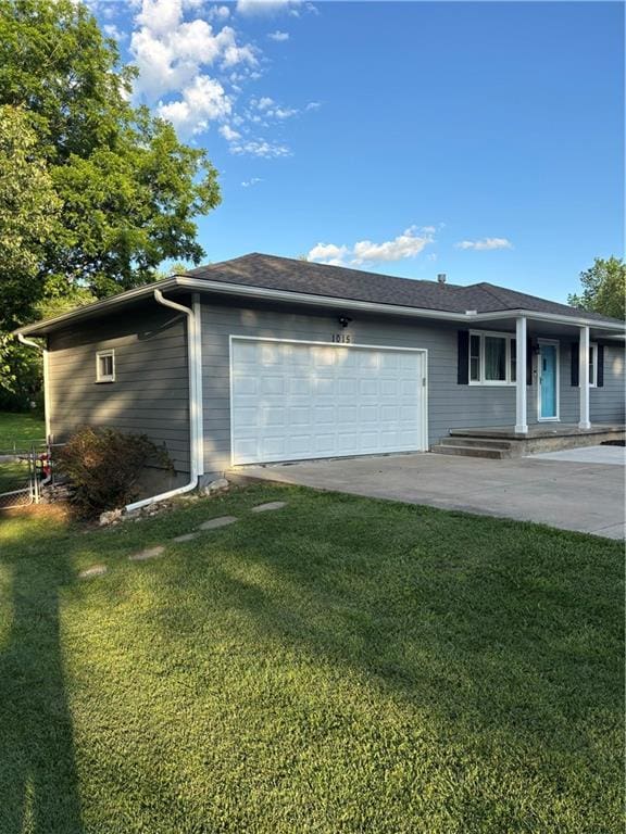 1015 S Elm St, Ottawa, KS 66067 - view of home's exterior with a garage, a yard, and driveway