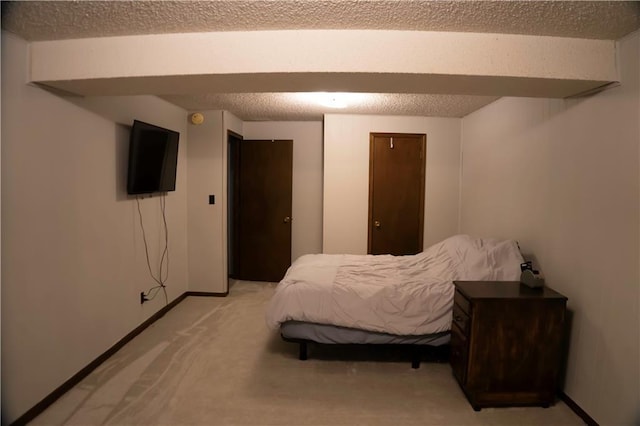 1015 S Elm St, Ottawa, KS 66067 - bedroom with light colored carpet, baseboards, and a textured ceiling
