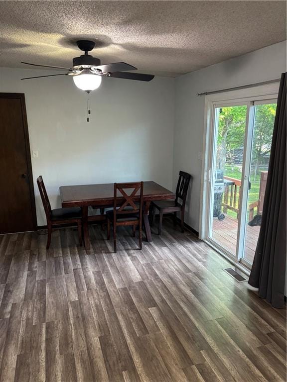 1015 S Elm St, Ottawa, KS 66067 - dining space with a textured ceiling, dark wood-style flooring, and a ceiling fan