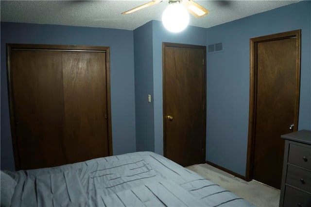 1015 S Elm St, Ottawa, KS 66067 - bedroom with a closet, a textured ceiling, light carpet, and ceiling fan