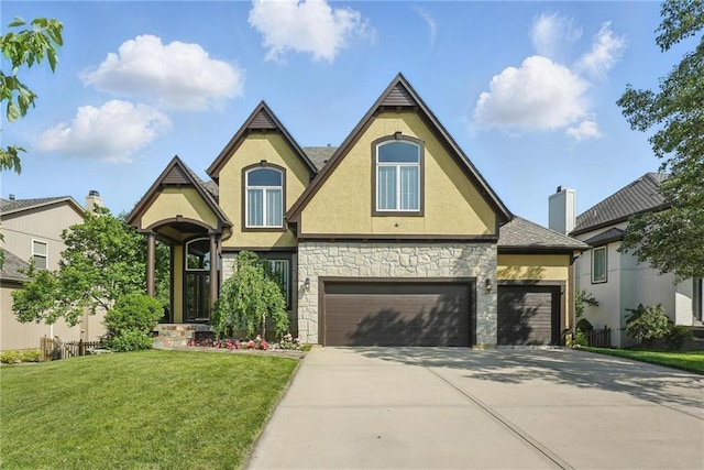 7407 W 145th Ter, Overland Park, KS 66223 - view of front of home with stucco siding, stone siding, concrete driveway, a front yard, and a garage