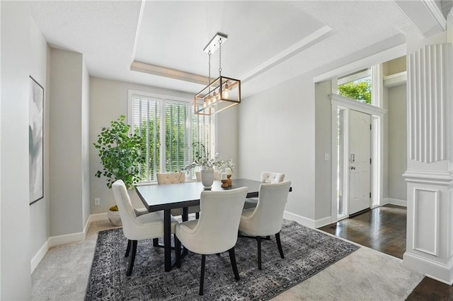 7407 W 145th Ter, Overland Park, KS 66223 - dining area featuring a chandelier, a raised ceiling, and baseboards