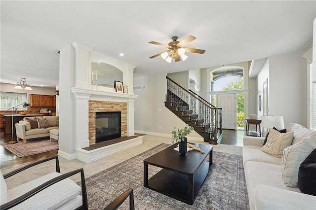 7407 W 145th Ter, Overland Park, KS 66223 - living room with stairway, a fireplace, a ceiling fan, recessed lighting, and baseboards