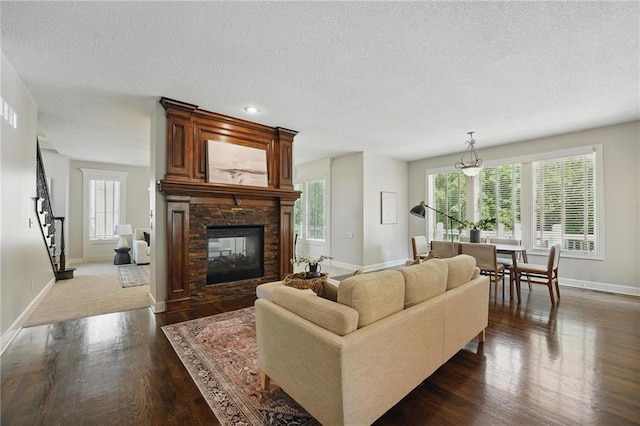 7407 W 145th Ter, Overland Park, KS 66223 - living area with wood finished floors, baseboards, a textured ceiling, and a fireplace