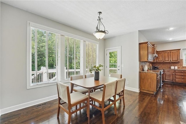 7407 W 145th Ter, Overland Park, KS 66223 - dining room featuring baseboards, healthy amount of natural light, dark wood-style floors, recessed lighting, and a textured ceiling
