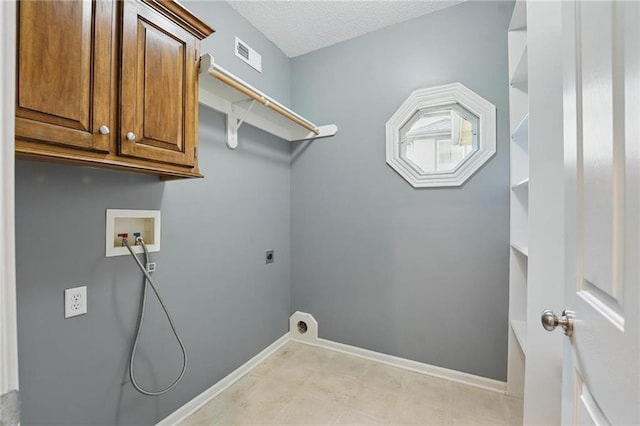 7407 W 145th Ter, Overland Park, KS 66223 - washroom with cabinet space, washer hookup, hookup for an electric dryer, baseboards, and a textured ceiling