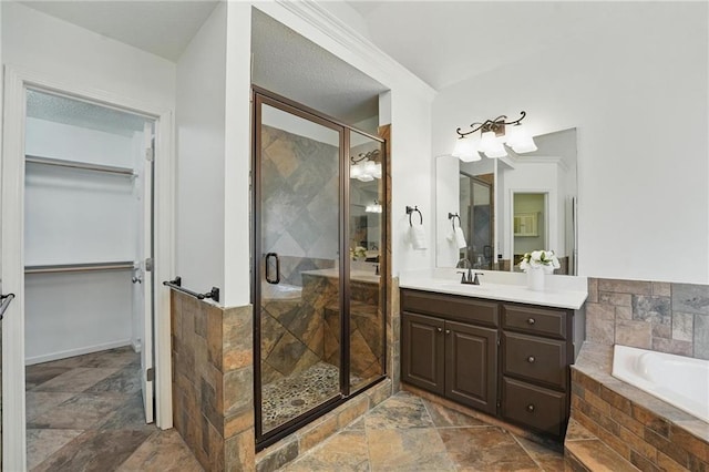 7407 W 145th Ter, Overland Park, KS 66223 - full bath featuring vanity, stone tile floors, a shower stall, a garden tub, and a spacious closet