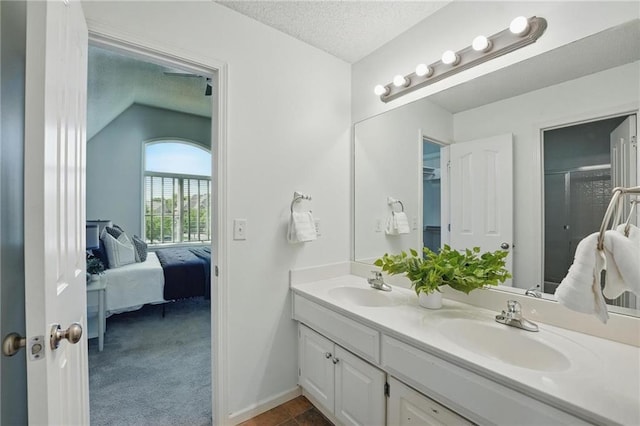 7407 W 145th Ter, Overland Park, KS 66223 - full bath with double vanity, ensuite bathroom, a textured ceiling, a shower stall, and baseboards