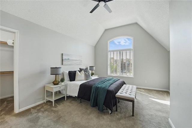 7407 W 145th Ter, Overland Park, KS 66223 - carpeted bedroom with a textured ceiling, vaulted ceiling, a walk in closet, ceiling fan, and baseboards