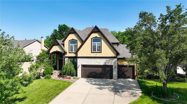 7407 W 145th Ter, Overland Park, KS 66223 - tudor-style house with stone siding, stucco siding, concrete driveway, a front yard, and a garage