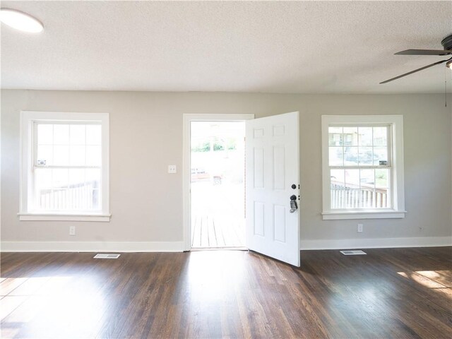 4941 Park Ave, Kansas City, MO 64130 - foyer featuring a ceiling fan, dark wood-type flooring, baseboards, and a textured ceiling
