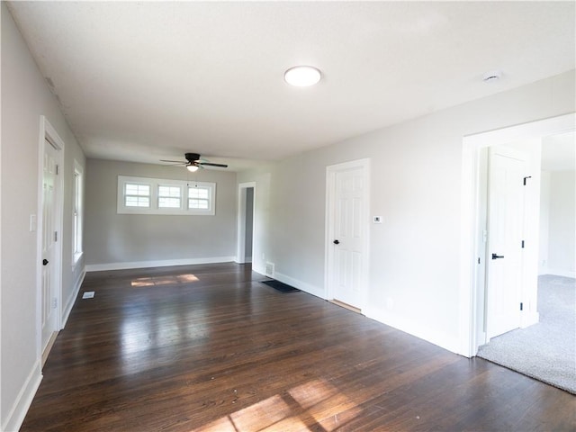 4941 Park Ave, Kansas City, MO 64130 - unfurnished room with dark wood-style flooring, a ceiling fan, and baseboards