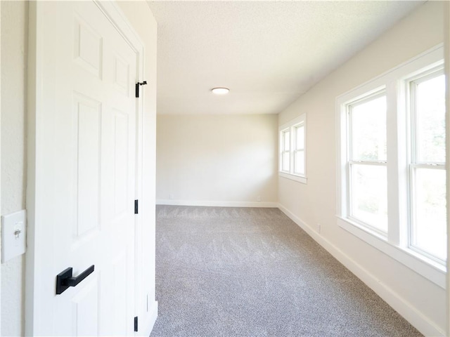 4941 Park Ave, Kansas City, MO 64130 - spare room featuring carpet floors and baseboards