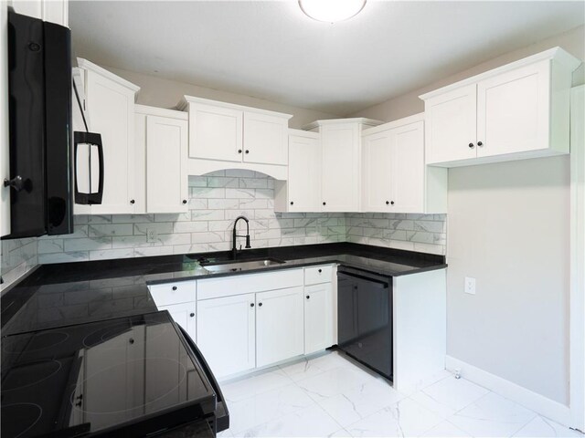 4941 Park Ave, Kansas City, MO 64130 - kitchen with a sink, black appliances, dark countertops, and white cabinets
