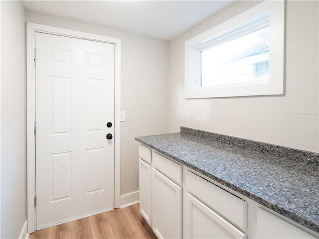 4941 Park Ave, Kansas City, MO 64130 - doorway to outside with light wood-type flooring and baseboards