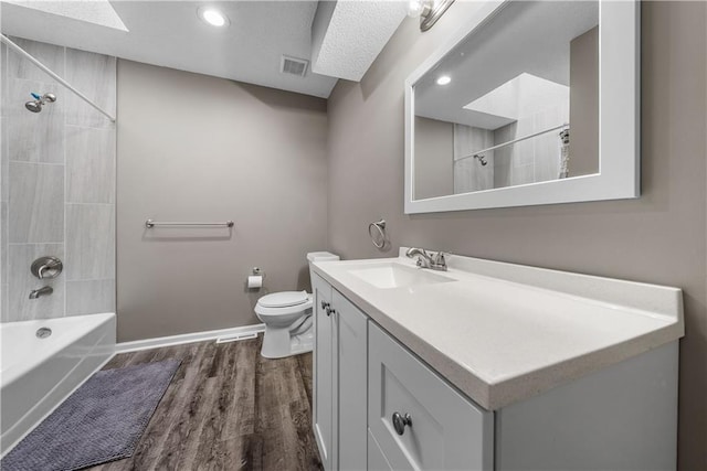 1728 SE 7th Ter, Lees Summit, MO 64063 - bathroom featuring vanity, toilet, wood finished floors, shower / washtub combination, and baseboards