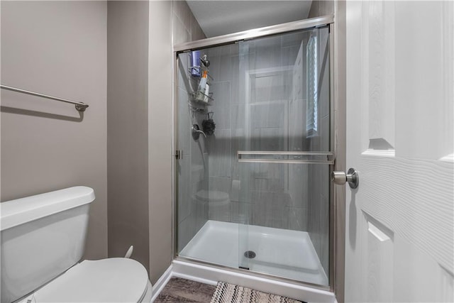 1728 SE 7th Ter, Lees Summit, MO 64063 - bathroom featuring toilet, a shower stall, and baseboards