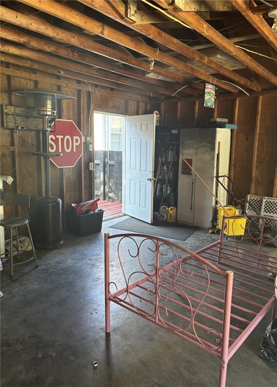 611 W Main St, Chanute, KS 66720 - misc room with concrete flooring and wood walls